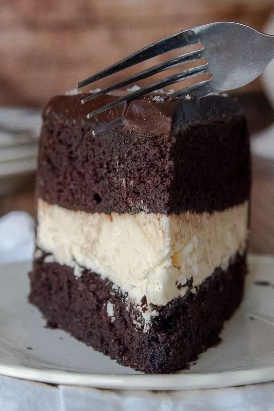 Čokoládová torta s krémovou náplňou a čokoládovou polevou.